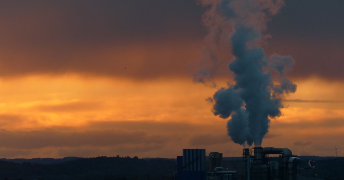 Plumes of smoke are released into the sky from a chemical plant chimney