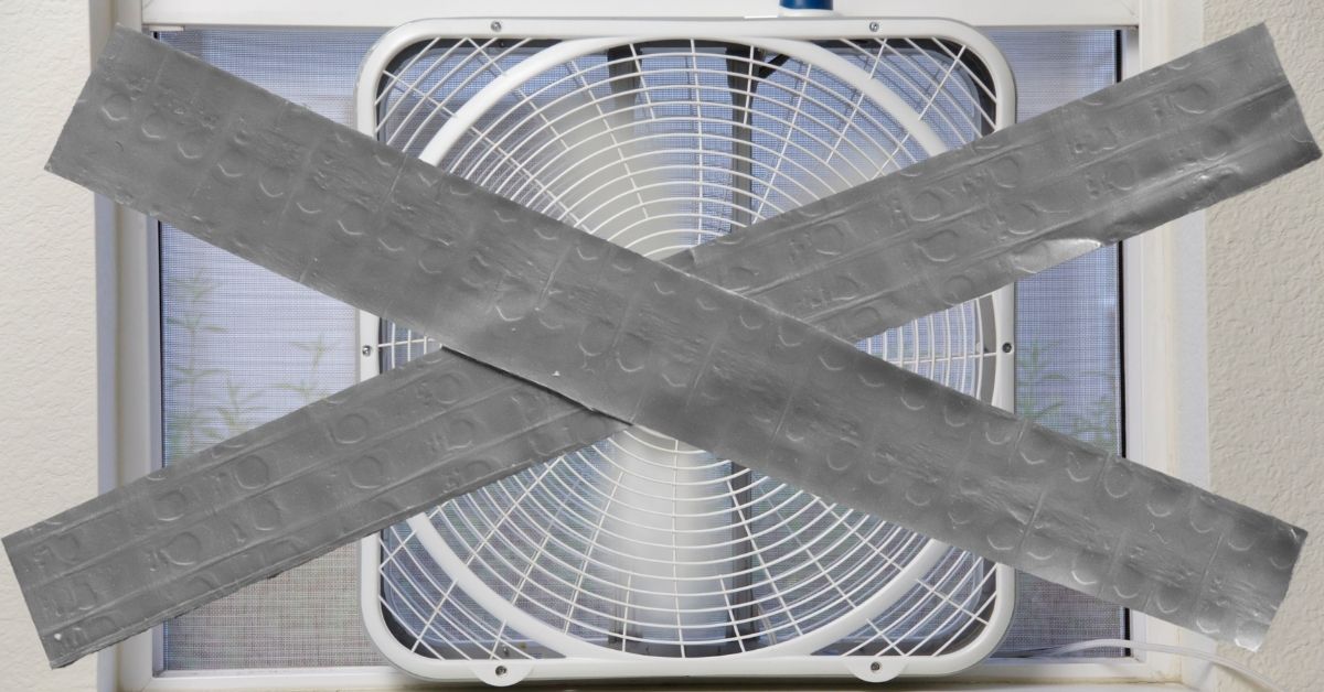 A photo of a box fan with tape laid over it in the shape of a cross