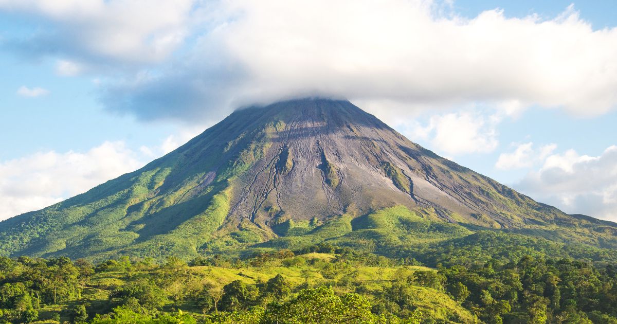 Volcano with clouds hovering over the top