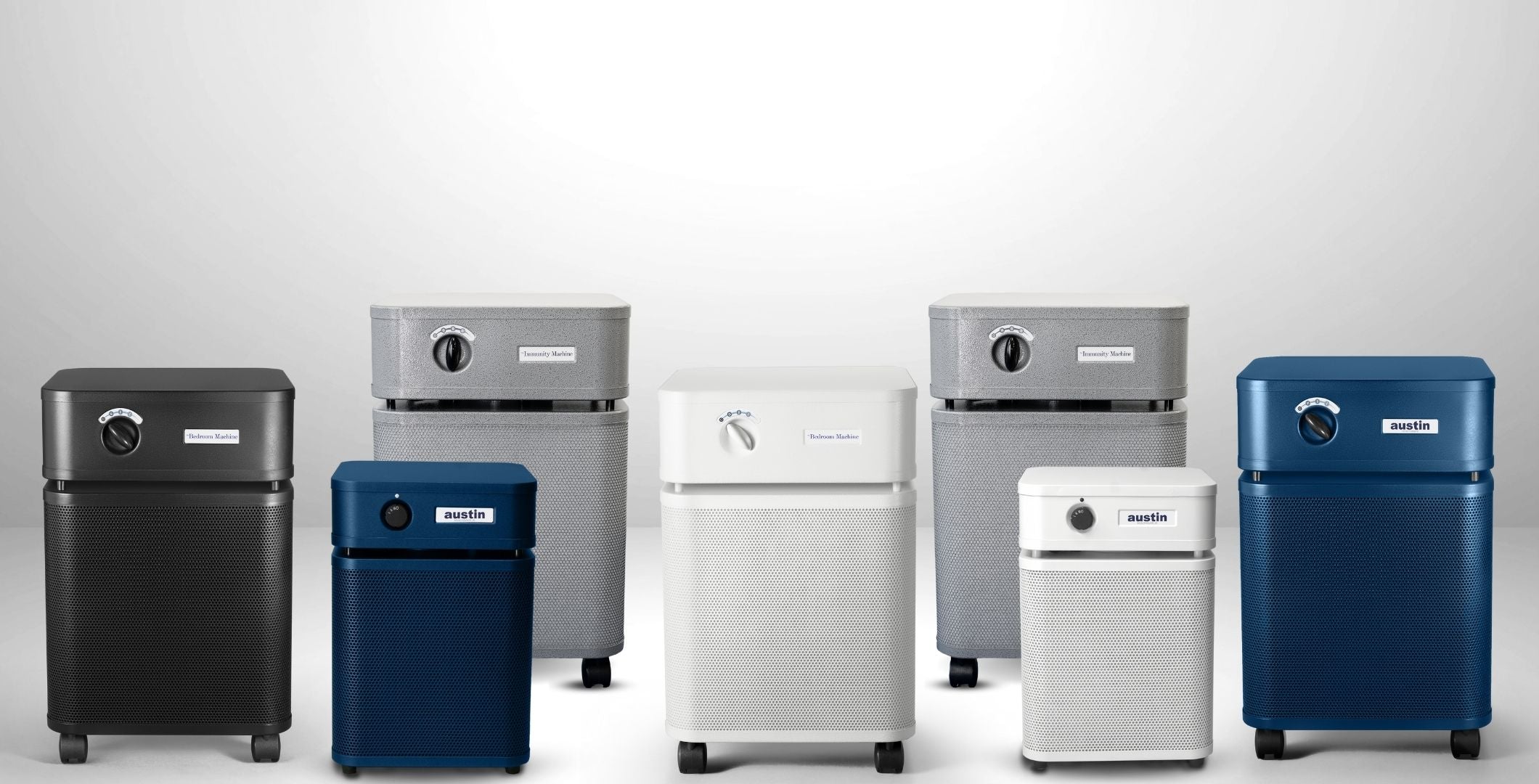 Collection of air purifiers in various colors on a white background