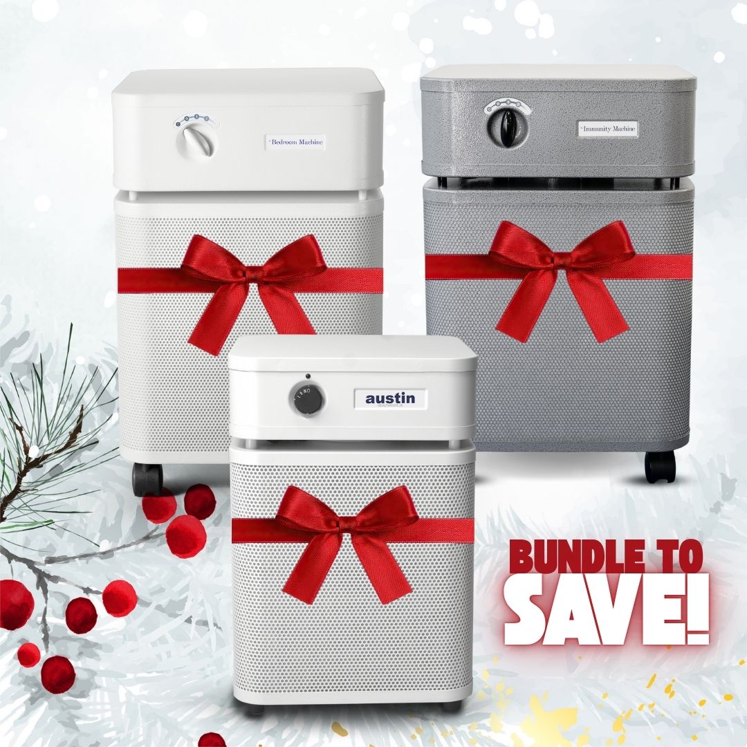 Three air purifiers with red ribbons on a snowy background, featuring the brand 'austin'.