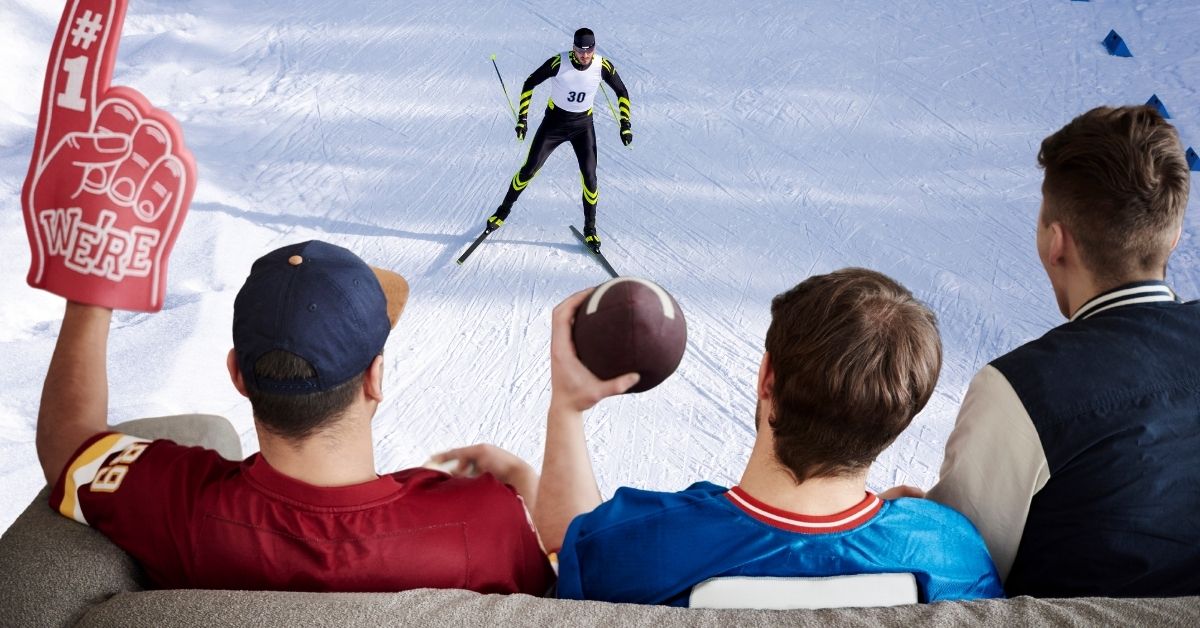 A photo mixing two different scenes to relate to the Super Bowl and 2026 Winter Olympics. There is a competitive skier racing downhill and at the bottom we see a back view of three men on a couch in football jerseys.