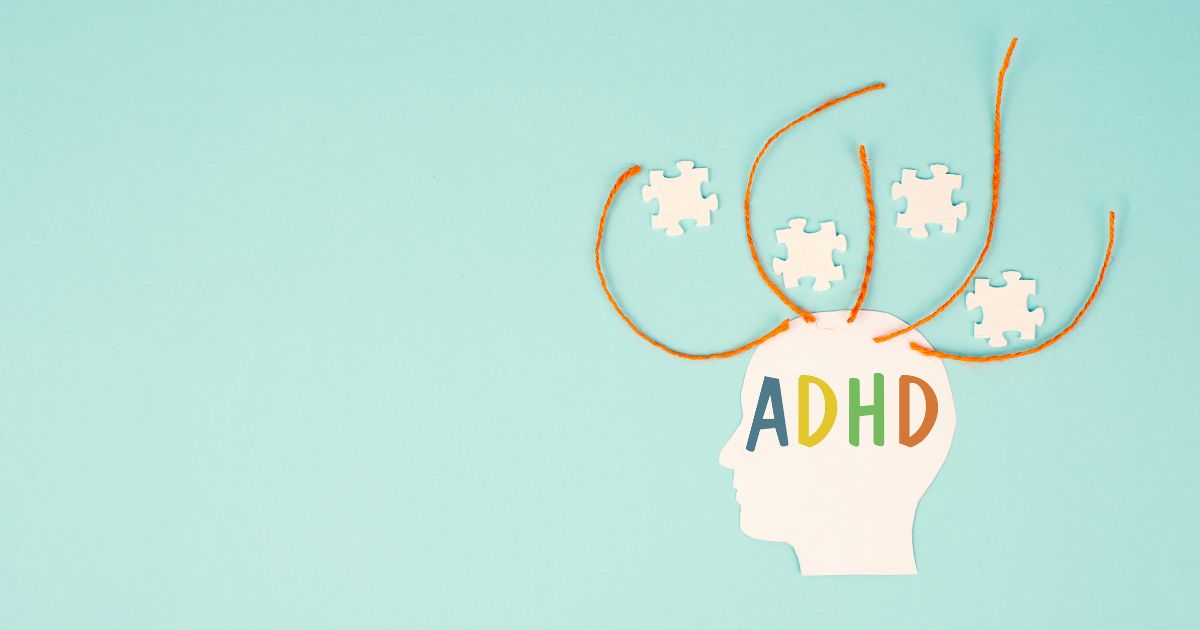 Graphic of a head with ADHD written over the top. Above the head jigsaw puzzle pieces are scattered around