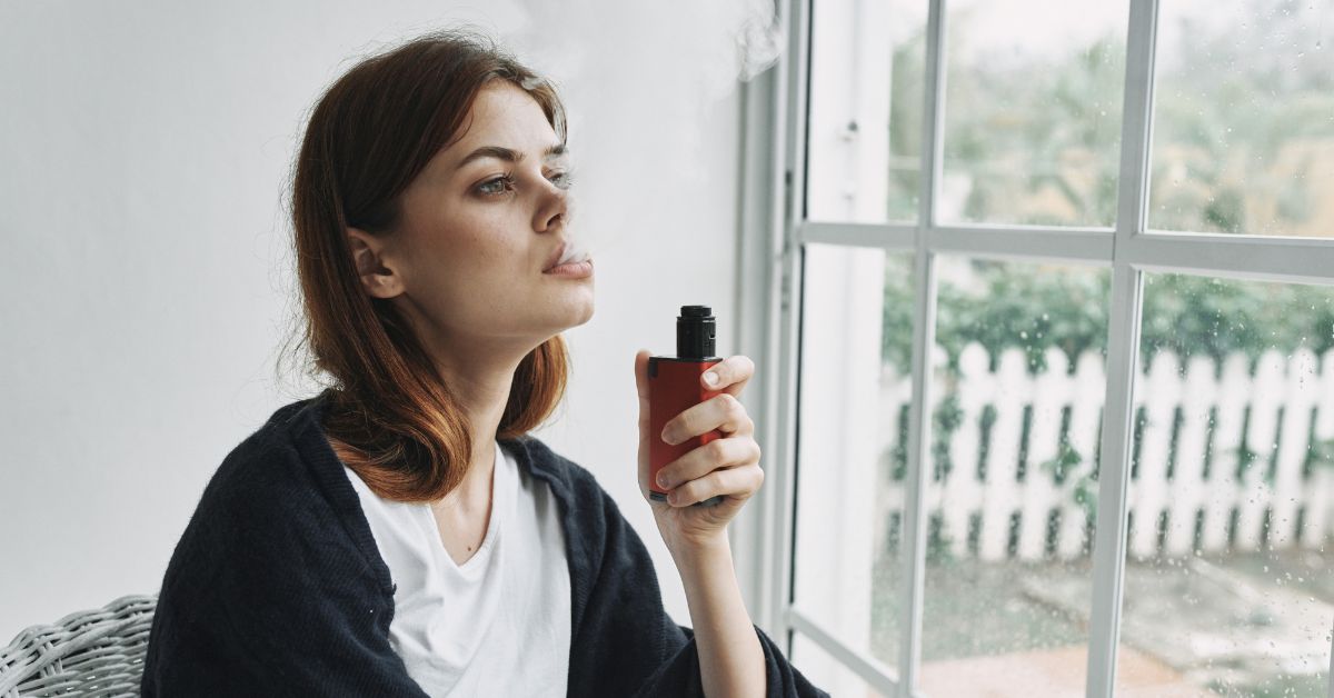 Young woman smoking an e-cigarette