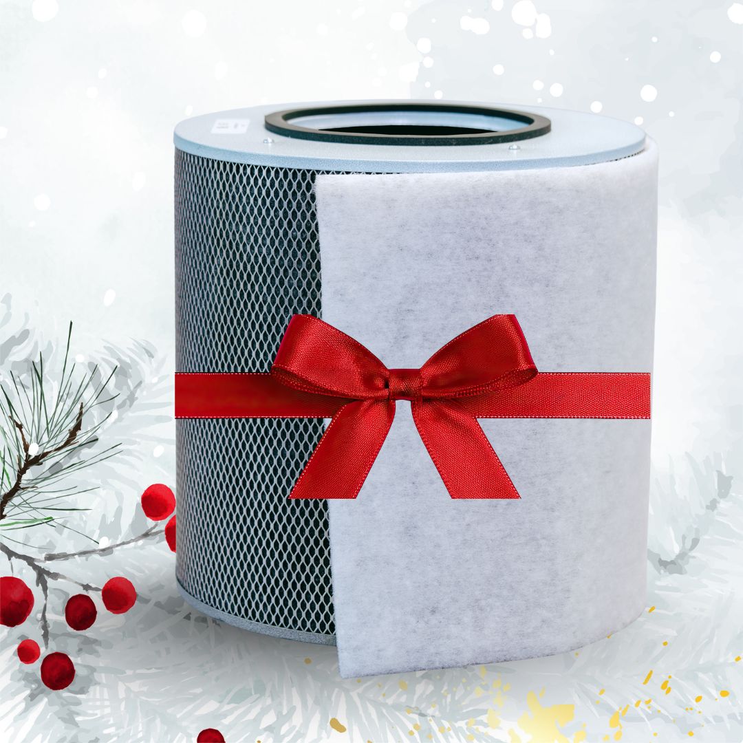Air filter wrapped in white paper with a red ribbon on a snowy background