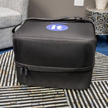 austin air "it" black carrying case on a patterned table 