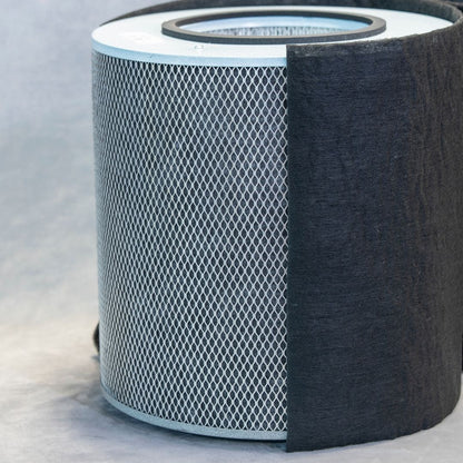 Cylindrical air filter with a black exterior and white interior on a light gray background
